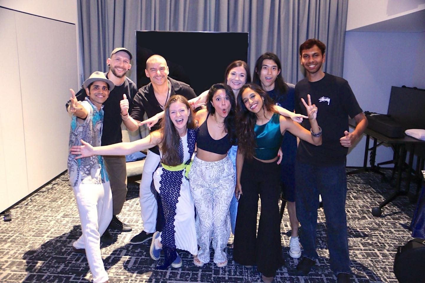 Diverse group of music students and professionals celebrating together at a Musicpath Pro live showcase event.