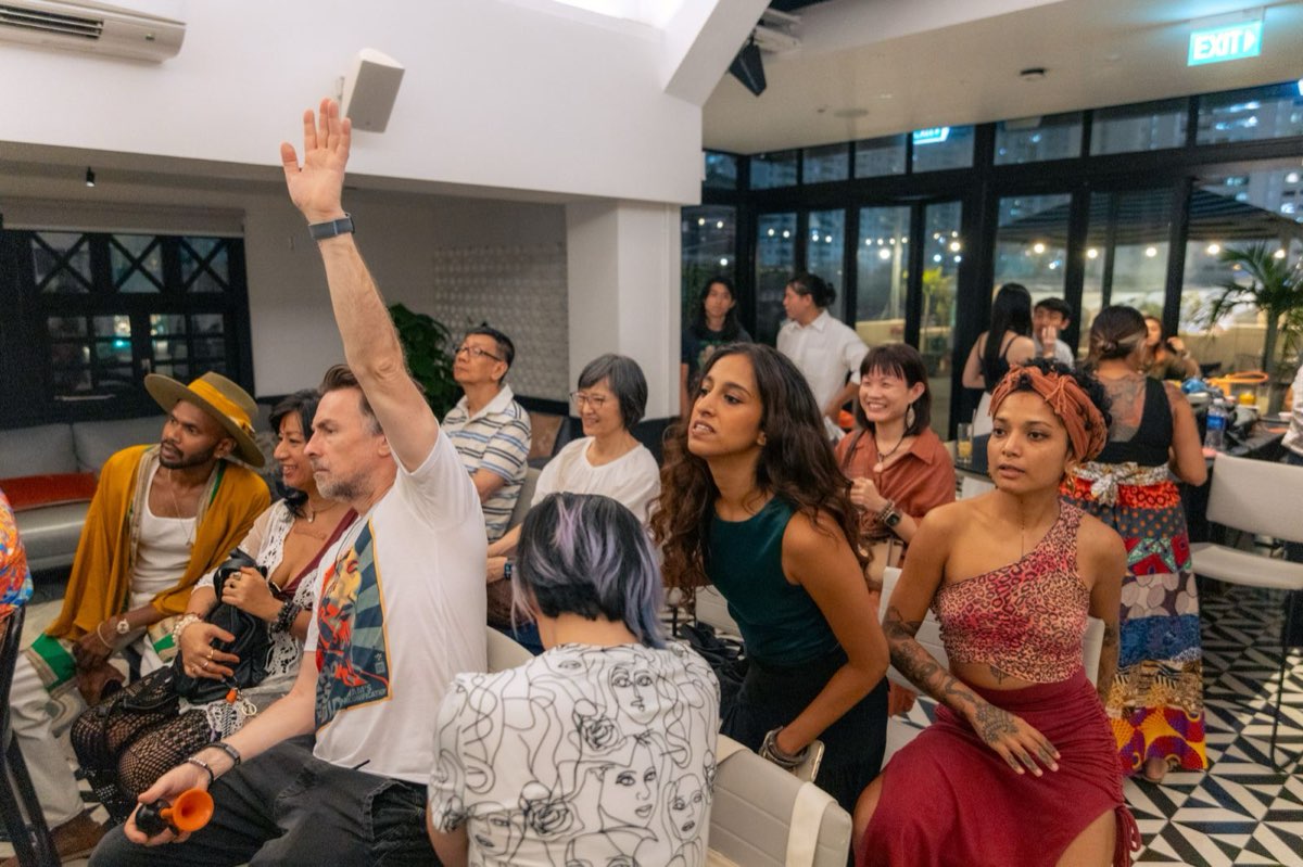 Engaged audience raising hands during a Musicpath Pro live coaching session, reflecting the program's weekly support and feedback.